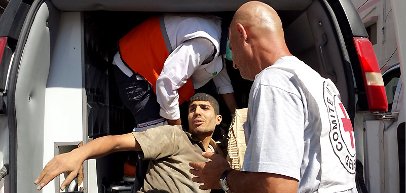 Source: ICRC (Shujaia, Gaza. ICRC staff transfer a casualty to an ambulance for evacuation)