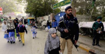 Following the murder of 132 schoolchildren and nine adults in an army school in Peshawar, the government has pledged to increase surveillance in schools. Here, schoolchildren walk alongside police in Pakistan. Image credit: Flickr (Jordi Bernabeu Farrús) Creative Commons. 
