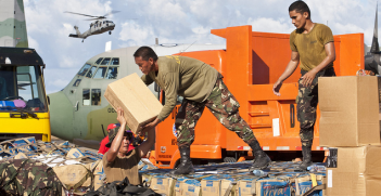 Philippines military members load relief aid. Image credit: Flickr (Department of Foreign Affairs and Trade) Creative Commons.