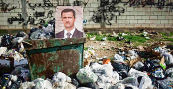A picture of Assad sits in a dumpster in Syria. Turkey's president wants to ensure the Kurds do not get their own state in northern Syria. Photo Credit: Flickr (Freedom House) Creative Commons.