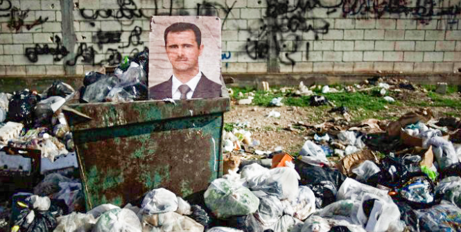 A picture of Assad sits in a dumpster in Syria. Turkey's president wants to ensure the Kurds do not get their own state in northern Syria. Photo Credit: Flickr (Freedom House) Creative Commons.