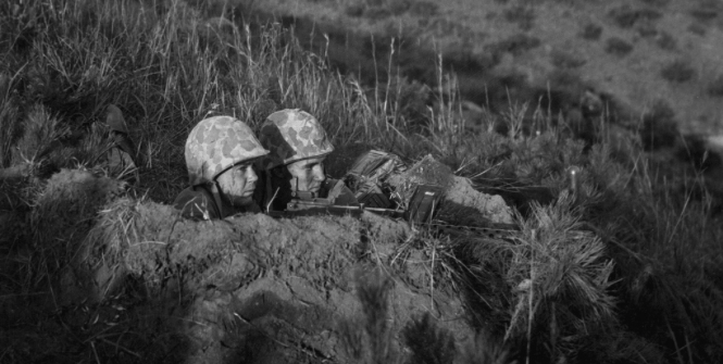 Two soldiers in a foxhole during the Korean war. Photo Credit: Flickr (Morning Calm Weekly Newspaper) Creative Commons.