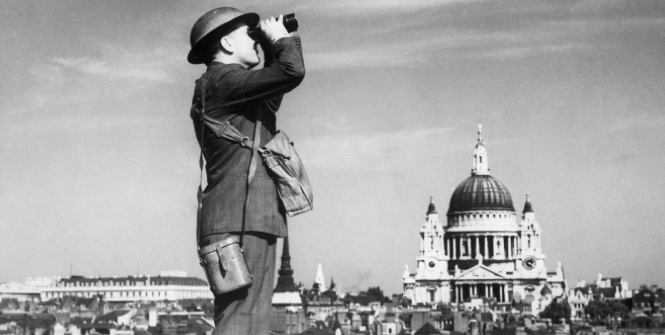 A man scans the sky for German planes during the Battle of Britain. Photo Credit: Wikimedia Commons (ZoomMedia) Creative Commons.