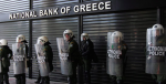 Policemen guard the shuttered National Bank of Greece. Photo Credit: Flickr (Global Panorama) Creative Commons.