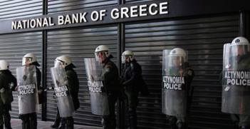 Policemen guard the shuttered National Bank of Greece. Photo Credit: Flickr (Global Panorama) Creative Commons.