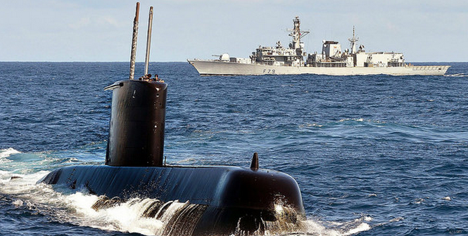 South African Navy submarine SAS Charlotte Maxeke cuts through the surface ahead of Type 23 frigate HMS Portland during an exercise off the coast of South Africa. Photo Credit: Flickr (Defence Images) Creative Commons