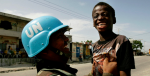 A Bolivian UN peacekeeper playfully picks up a Haitian boy at a checkpoint in Cité Soleil. Photo Credit: Flickr (United Nations Photo) Creative Commons