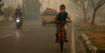 A student goes to school wearing a mask to protect him from the smoke that blankets the city of Palangka Raya, Central Kalimantan. Photo Source (Flickr) CIFOR. Creative Commons.