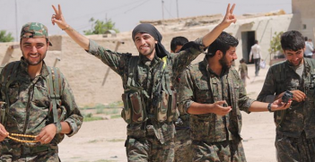 YPG fighters walking back to base celebrating from a victory. August 2015. Photo Source: Wikimedia (Flickr). Creative Commons.