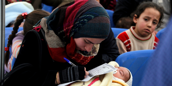 A Syrian refugee filling an application at the UNHCR registration center in Tripoli, Lebanon. Photo Source: World Bank Photo Collection (Flickr). Creative Commons.