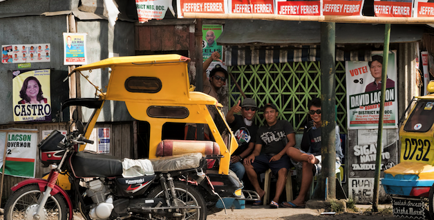 Pedicab waiting station surrounded by election material in Silay City, Philippines. Photo source: Brian Evans (Flickr). Creative Commons.