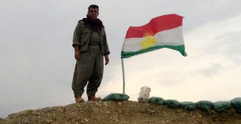 Kurdish fighter withe the Kurdish flag, photo by Kurdishstruggle