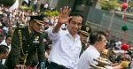 President Jokowi waves to a crowd in Jakarta