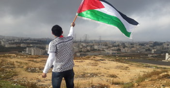 Man waving Palestinian flag