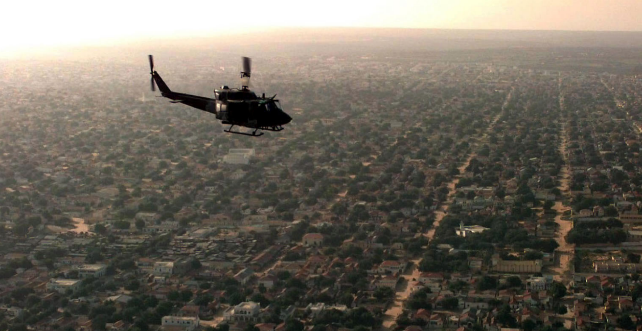 A US UH-1N Huey helicopter flew over Mogadishu on a patrol mission to look for signs of hostilities, 1 December 1992 (Credit: US Department of Defense).