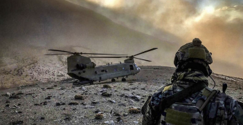 An airman observes an Army CH-47 Chinook helicopter at an undisclosed location in Afghanistan. Will US soldiers finally be going home? Source: US Army