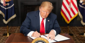 US President Donald Trump signs an executive order imposing sanctions on Iran in 2018.  Source: The White House