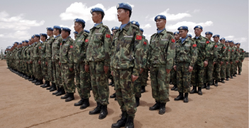 Newly arrived engineers from China serving with the United Nations-African Union Mission in Darfur (UNAMID) stand to attention after arriving in Nyala, South Darfur. Source: Stuart Price https://bit.ly/2vHorw6