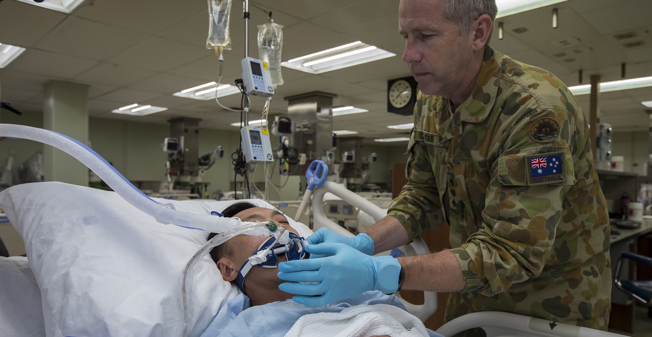 Australian Army Reserve Nursing Officer Captain William Cater assesses an intensive care patient onboard hospital ship USNS Mercy (T-AH 19), during Pacific Partnership 2016. Pacific Partnership is an annual deployment of forces designed to strengthen maritime and humanitarian partnerships during disaster relief operations, while providing humanitarian, medical, dental and engineering assistance to nations of the Pacific. Source: Australian Defence Force photo by Cpl. David Cotton https://bit.ly/35d6vXj