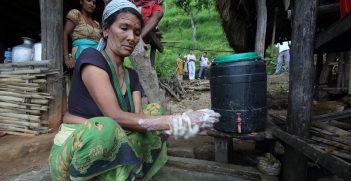 Woman washes her hands using water collected from the village gravity flow taps at a NEWAH WASH water project in Puware Shikhar, Udayapur District, Nepal. Source: Jim Holmes/AusAID https://bit.ly/351OawC