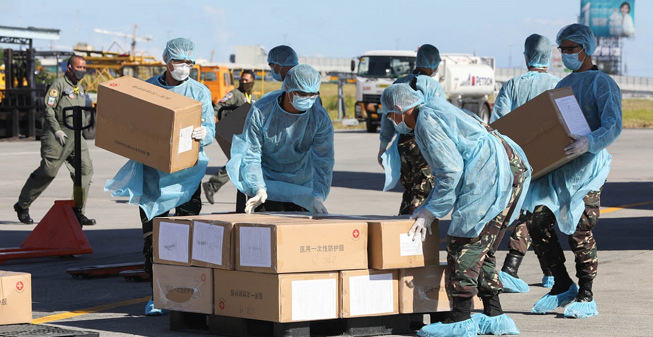 Aid packages donated by the People's Republic of China are unloaded at the Villamor Air Base in Pasay City, Philippines. The donation includes assorted medical supplies, personal protective equipment, and testing kits for coronavirus. Source: Toto Lozano https://bit.ly/3cqN546