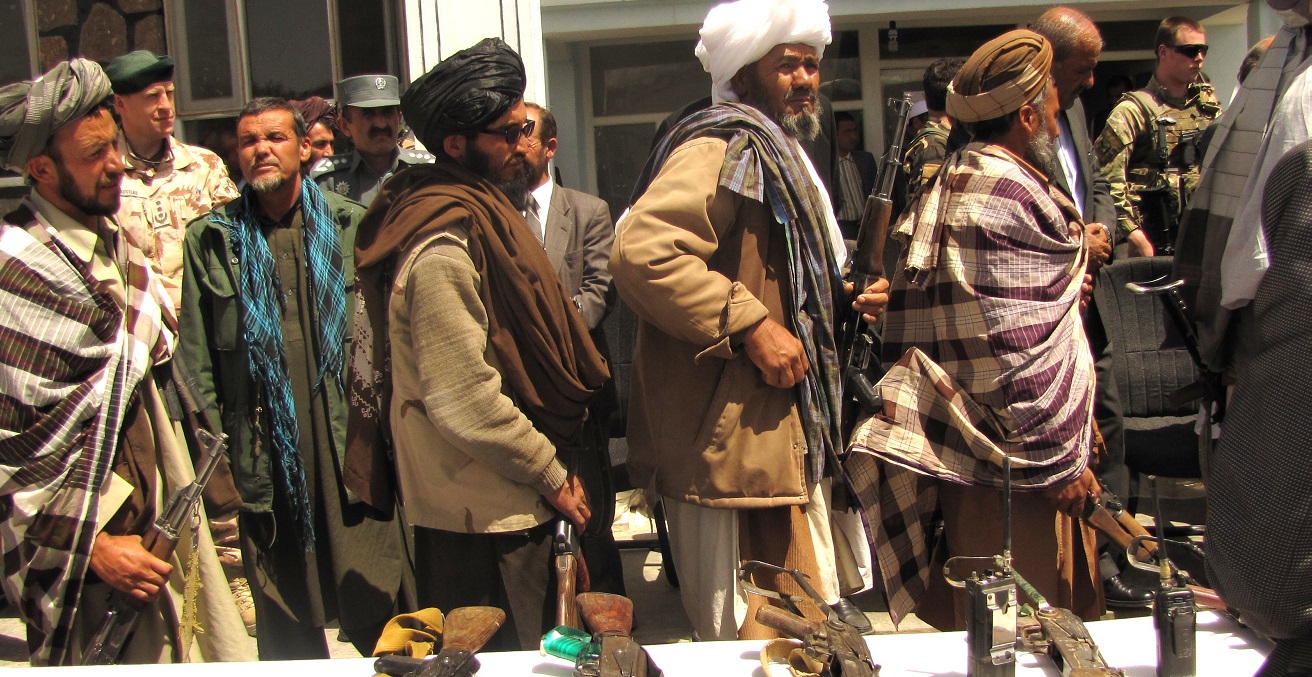 Former Taliban fighters line up to handover their Rifles to the Government of the Islamic Republic of Afghanistan during a reintegration ceremony at the provincial governor’s compound. Source: Department of Defense, Lt. j. g. Joe Painter https://bit.ly/3eUIbgY