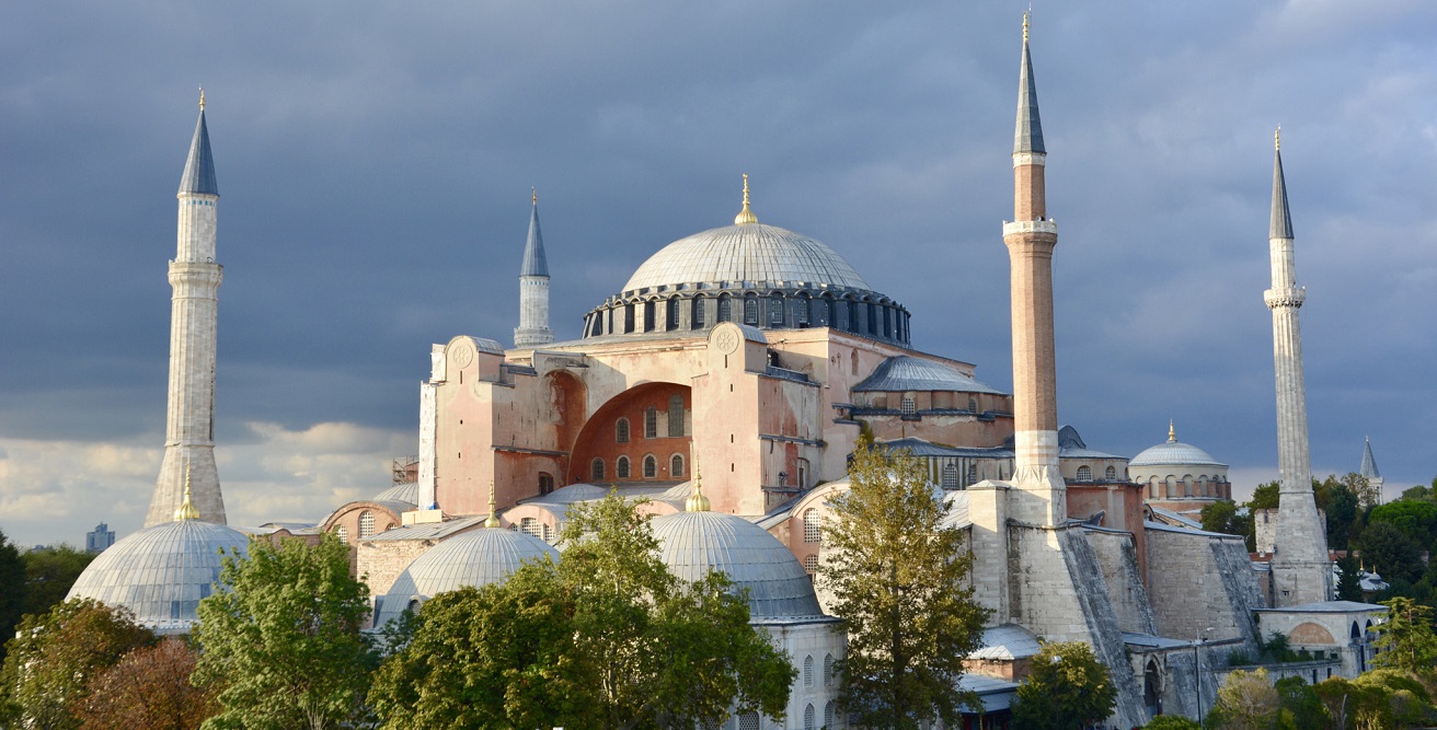 A photo of the Hagia Sophia surrounded by trees and dark clouds. Source: Adli Wahid https://bit.ly/32eHjAr