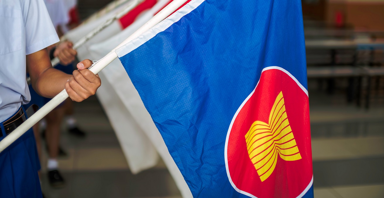 Hand holding Fabric Flags of the Association of Southeast Asian Nations. Source: BeanRibbon/Shutterstock.