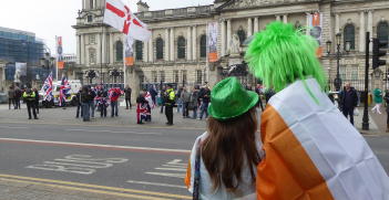 Within 40 minutes of the St Patrick's Day Parade leaving Belfast City Hall, Loyalist flag protesters appear at the same City Hall. Belfast City Hall, Belfast, Northern Ireland, March 2015. Source: Ardfern https://bit.ly/3wYIWOq