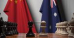 A chessboard in front of Australian and Chinese flags. Source: Shutterstock.