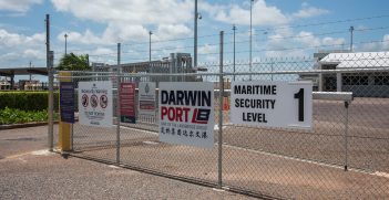 Border patrol area fence with signs at the port in the waterfront district of Darwin, Australia. Source: EA Given/Shutterstock