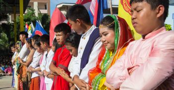 Students dress up with National ASEAN costume and shaking hands together for ASEAN Day in Chonburi high school on August 8,2017. Source: BeanRibbon/Shutterstock