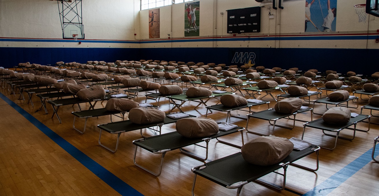 Cots are set up in the fitness center at Naval Station (NAVSTA) Rota to accommodate evacuees from Afghanistan in anticipation of their arrival. NAVSTA Rota is currently supporting the Department of Defense mission to facilitate the save departure and relocation of U.S. citizens, Special Immigration Visa recipients and vulnerable Afghan populations from Afghanistan. (U.S. Navy photo by Mass Communication Specialist 1st Class Nathan Carpenter)