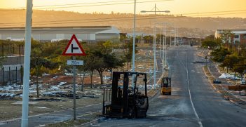  A burnt forklift abandoned in the road, with debris scattered around after a riot passed through the industrial area in Durban, South Africa on 15 July 2021. Source:  Gareth_Bargate/ Shutterstock.