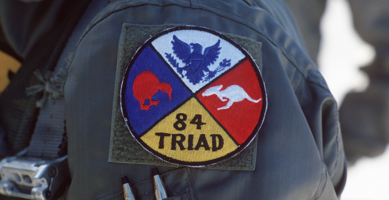   An airman wears a patch commemorating the joint Australian, New Zealand and US (ANZUS) Exercise TRIAD '84. Source: MSGT David N. Craft https://bit.ly/3l50mVE
