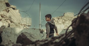 Eight-year-old Yasin plays in rubble. Source: Mike KHALAF/ICRC