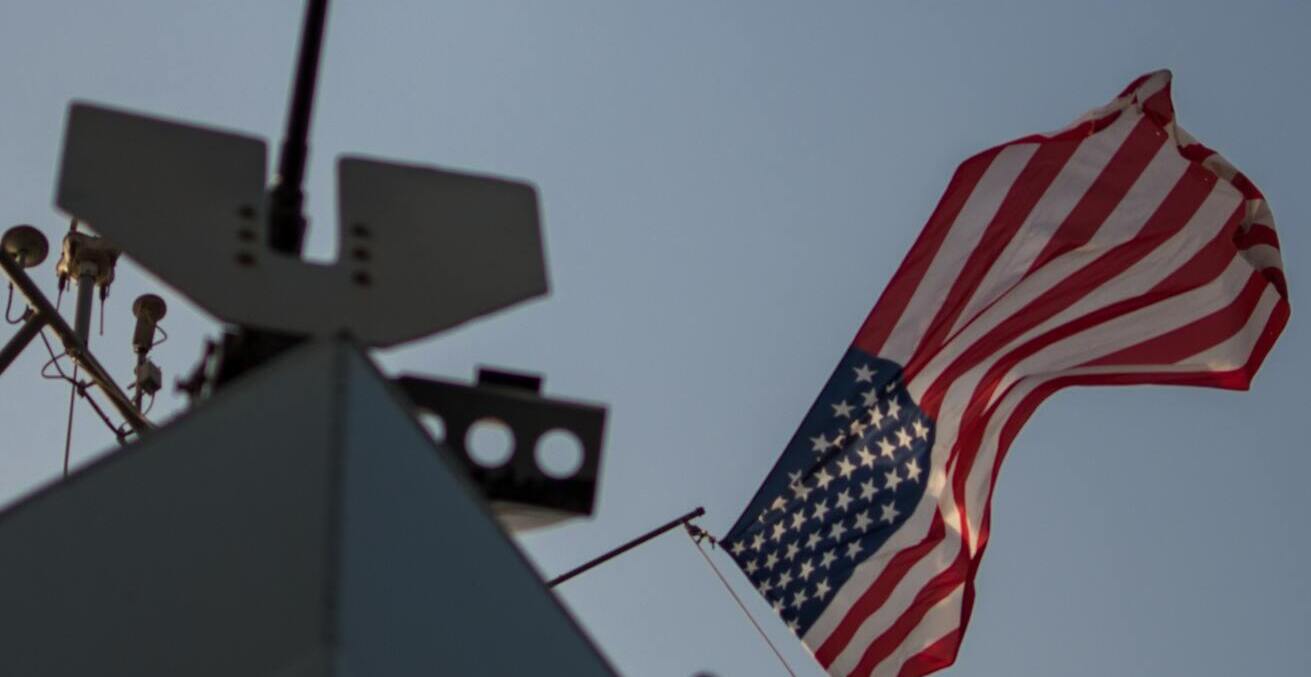 A US Navy boat proudly sails its flag, credit: Thomas Ashlock, https://bit.ly/35VenRW