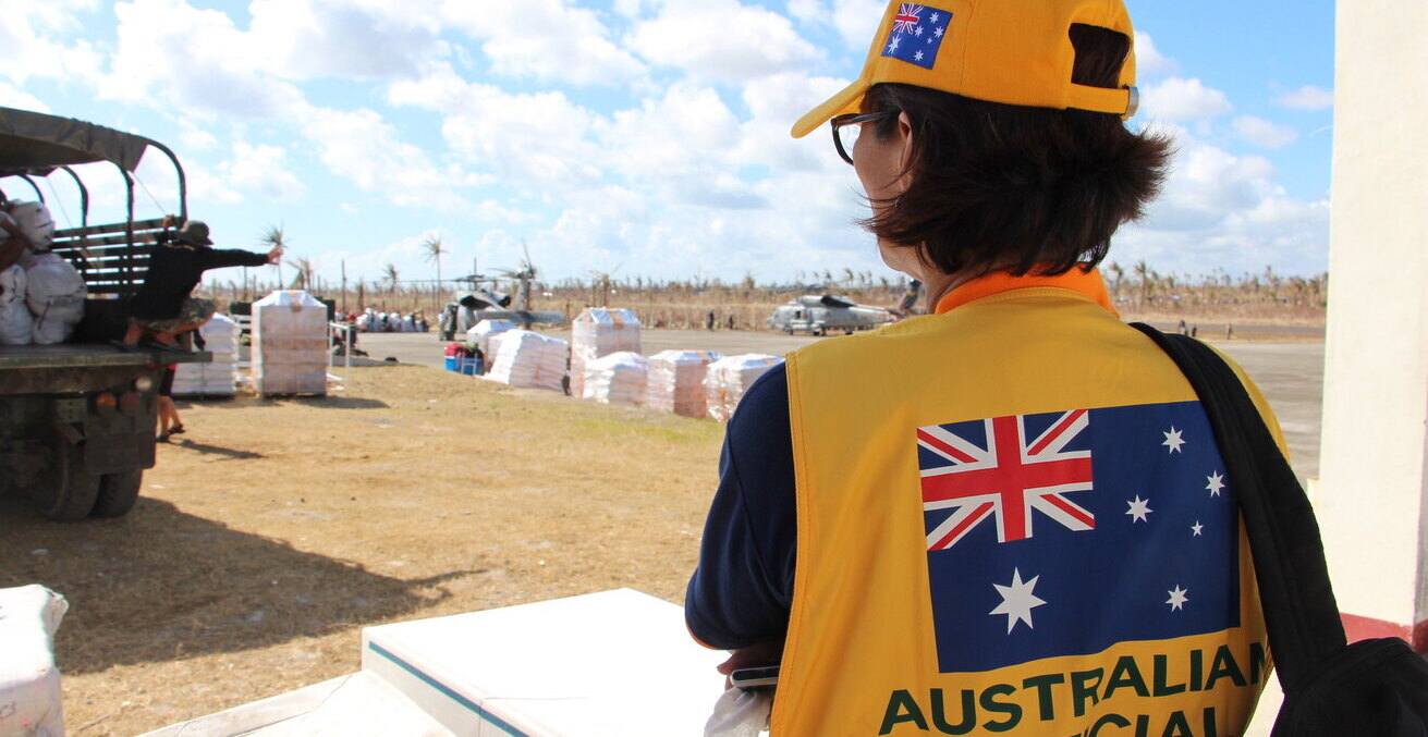Australian Embassy official Eva Yazon on site observing humanitarian relief efforts in Guiuan, The Philippines in 2014. Photographs: Gemma Haines / Department of Foreign Affairs and Trade, https://bit.ly/3tV62Y5. 