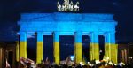 Rally on Pariser Platz in Berlin against Russia's invasion of Ukraine in front of the Brandenburg Gate illuminated with the Ukrainian flag. Source: https://bit.ly/3hEjKHC