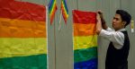 A volunteer hangs a rainbow flag at the 'Being LGBTI in Asia Thailand Country Dialogue', 2018.  Source: Wiraporn Srisuwanwattana, USAID, https://bit.ly/3QqWuNu