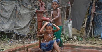 Two Rohingya boys wash themselves in Bangladesh. 
Source: , Pierre Prakash EU/ECHO 2013, https://bit.ly/3HrhjnU
