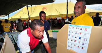 Electoral Commission workers show locals through the mock poll booth setup in Port Moresby, National Capital District 2012.
Source: AUSAid.
https://bit.ly/3OYz2Gp