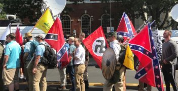 Charlottesville, 2017. Alt-right members preparing to enter Emancipation Park holding Nazi, Confederate, and Gadsden 