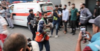 Medics transport an injured Palestinian child into Al-Shifa hospital in Gaza City following an Israeli airstrike on October 11, 2023. Source: Wafa / https://t.ly/O3zV3